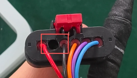Hole behind the wiring harness connector