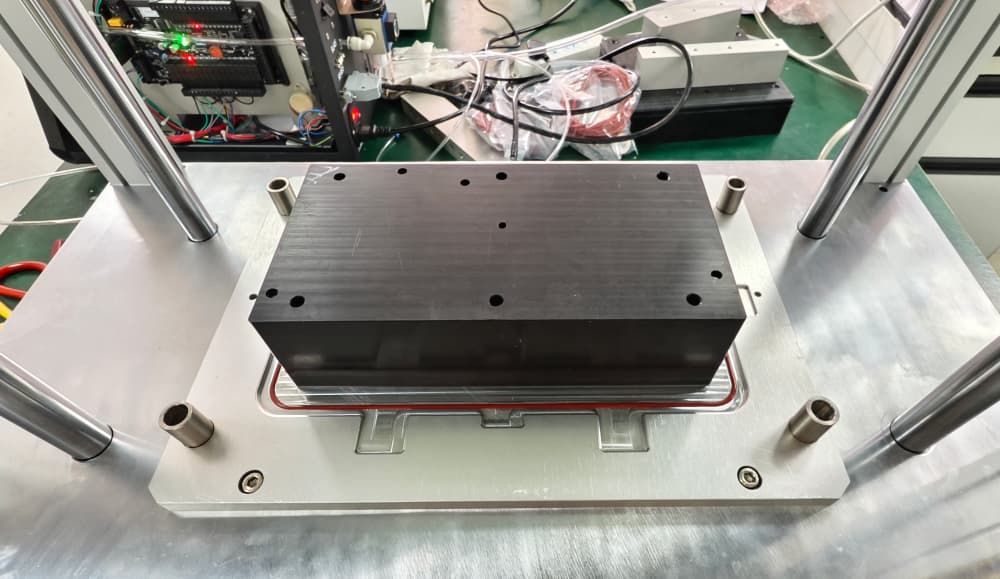 Lower fixture for wireless bridge enclosure leak tester